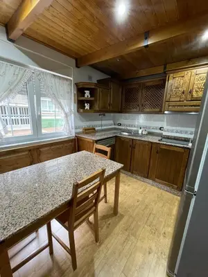 a kitchen with a table and a counter top at Apartamento La Veiga in Cerredo