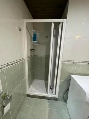 a shower with a glass door in a bathroom at Apartamento La Veiga in Cerredo