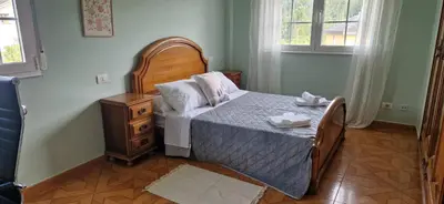 a bedroom with a bed and a dresser and window at El Rincón Del Silencio in Moucide