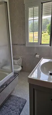 a bathroom with a sink and a shower and a toilet at El Rincón Del Silencio in Moucide