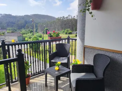 a balcony with two chairs and a table with a view at El Rincón Del Silencio in Moucide