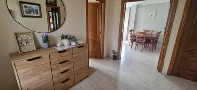 a room with a dresser with a mirror and a table at El Rincón Del Silencio in Moucide