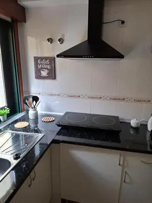 a kitchen with a counter top with a laptop on it at Piso DJC in O Pedrouzo
