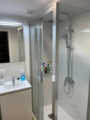 a bathroom with a shower and a sink at Casa duples junto playa Cubelas in San Ciprián
