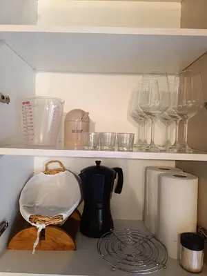 a kitchen shelf with a tea pot and wine glasses at Luz do Sil in Ourense