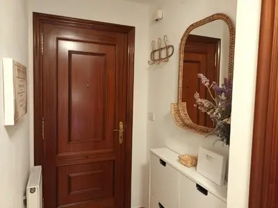 a bathroom with a wooden door and a mirror at Fogar da Fraga in Caldas de Reis