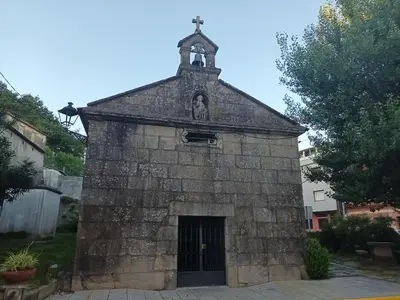 an old stone church with a cross on the top at Fogar da Fraga in Caldas de Reis