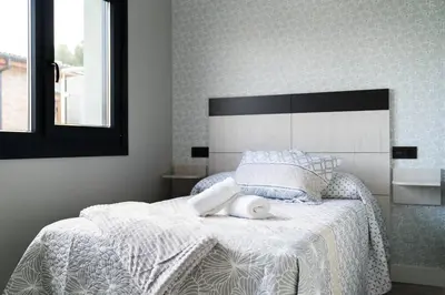 a bedroom with a bed with a white comforter at El Cañon By Silastur in El Espín