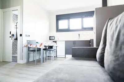 a living room with a table and a kitchen at El Cañon By Silastur in El Espín