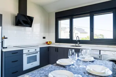 a kitchen with a table with plates and glasses on it at El Cañon By Silastur in El Espín