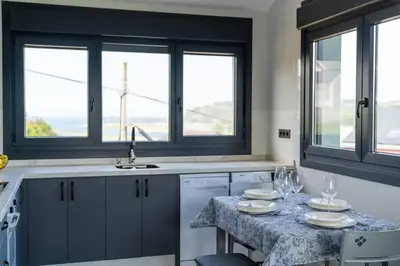 a kitchen with a table with wine glasses on it at El Cañon By Silastur in El Espín