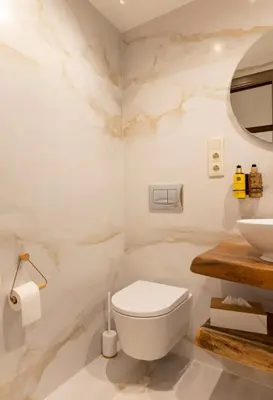 a bathroom with a white toilet and a sink at O Fogar da Pequena Galia in Caldas de Reis