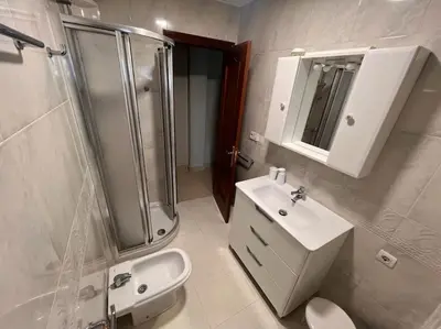 a bathroom with a shower and a sink and a toilet at Casa con terraza en el casco in Betanzos