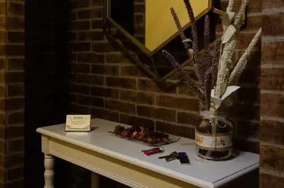a table with a vase of flowers on it at Braida Ribeira Sacra in Sober