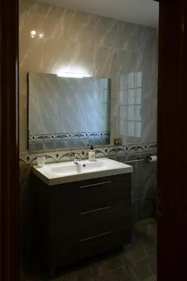 a bathroom with a sink and a large mirror at Braida Ribeira Sacra in Sober