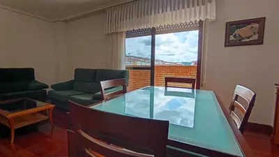 a living room with a glass table and a couch at O Xardín Termal in Ourense