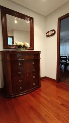 a dresser with a mirror on top of it at O Xardín Termal in Ourense