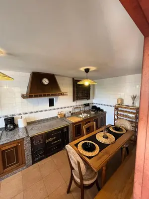 a large kitchen with a wooden table in a room at Casa Germán in A Coruña