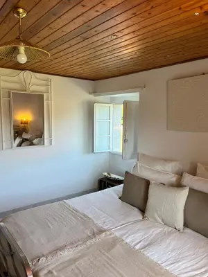 a bedroom with a large bed with a wooden ceiling at Casa Germán in A Coruña