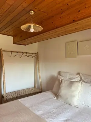 a bedroom with a bed with a wooden ceiling at Casa Germán in A Coruña