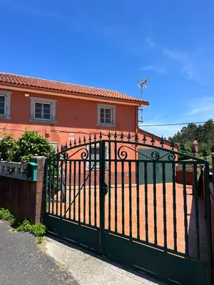 a black gate in front of a house at Casa Germán in A Coruña