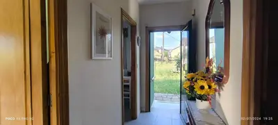 a hallway with a vase of sunflowers in a vase at Casa Mercedes in Quiroga
