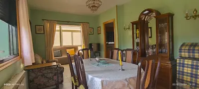 a dining room with a table and chairs in a room at Casa Mercedes in Quiroga