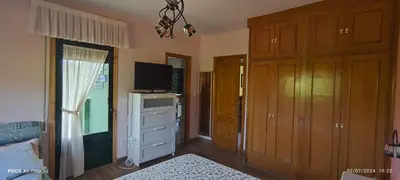 a bedroom with a bed and a tv and a dresser at Casa Mercedes in Quiroga
