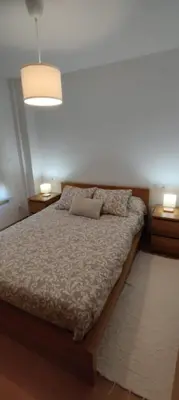 a bedroom with a bed with a lamp on it at Apartamento 
