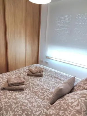 a bedroom with a bed with two towels on it at Apartamento 