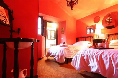 a red bedroom with two beds and a sink at Te Cuento 3 Xesteira in A Xesteira