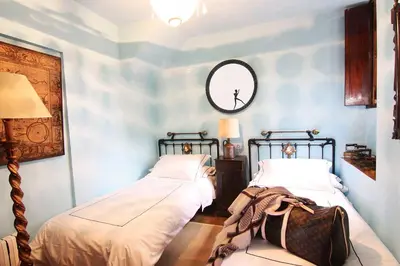 a bedroom with two beds and a mirror on the wall at Te Cuento 3 Xesteira in A Xesteira
