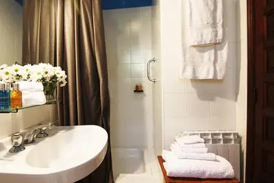 a bathroom with a sink and a shower with towels at Te Cuento 3 Xesteira in A Xesteira