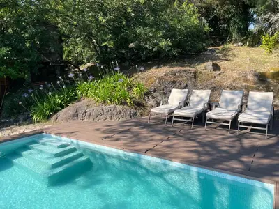 a group of chairs sitting next to a swimming pool at Te Cuento 3 Xesteira in A Xesteira