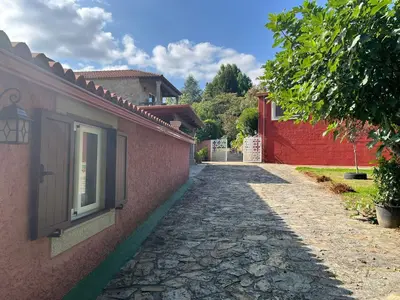 a stone walkway next to a building with a window at Casa Romeo in Brion
