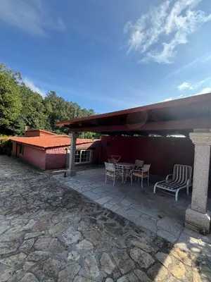 a patio with chairs and a table and a building at Casa Romeo in Brion