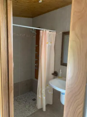 a bathroom with a shower curtain and a sink at Casa Romeo in Brion