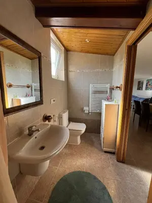 a bathroom with a sink and a toilet and a mirror at Casa Romeo in Brion
