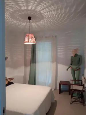 a bedroom with a bed and a mannequin in a chair at OLI VITA HOLIDAY HOME 4 O 2 PEOPLE Viveiro VUT-LU-3838 in Viveiro