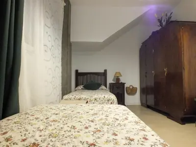 a bedroom with a bed and a dresser and a bed sidx sidx at OLI VITA HOLIDAY HOME 4 O 2 PEOPLE Viveiro VUT-LU-3838 in Viveiro
