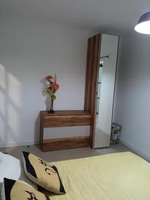 a room with a mirror and a vase with flowers at OLI VITA HOLIDAY HOME 4 O 2 PEOPLE Viveiro VUT-LU-3838 in Viveiro
