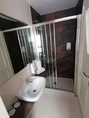 a bathroom with a sink and a shower at Hotel Miño in Ourense