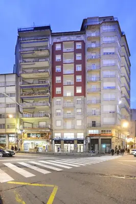 a large building on a city street at night at Hotel Miño in Ourense