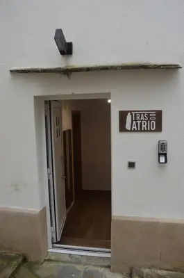 a sign on the side of a building with a door at Tras Do Atrio Casa en el Centro de Betanzos in Betanzos