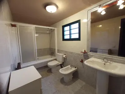 a bathroom with a toilet and a sink and a mirror at Galicia in Forcarei