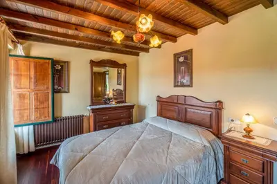 a bedroom with a bed and a dresser and a mirror at Galicia in Forcarei