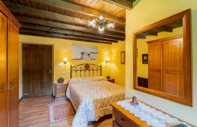a bedroom with a bed and a large mirror at Galicia in Forcarei