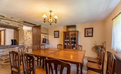 a dining room with a wooden table and chairs at Galicia in Forcarei