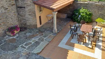 a patio with a table and chairs and a building at Galicia in Forcarei