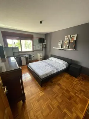 a bedroom with a bed and a wooden floor at Lusquefusque in Monforte de Lemos